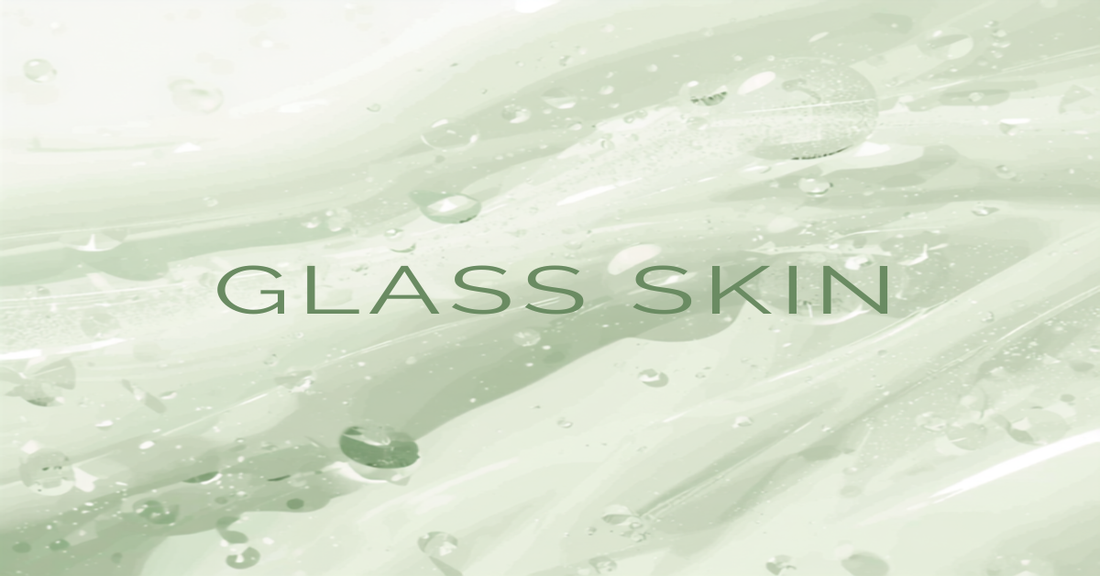 Fresh dewy gel texture with water droplets and the words Glass Skin on a soft green background